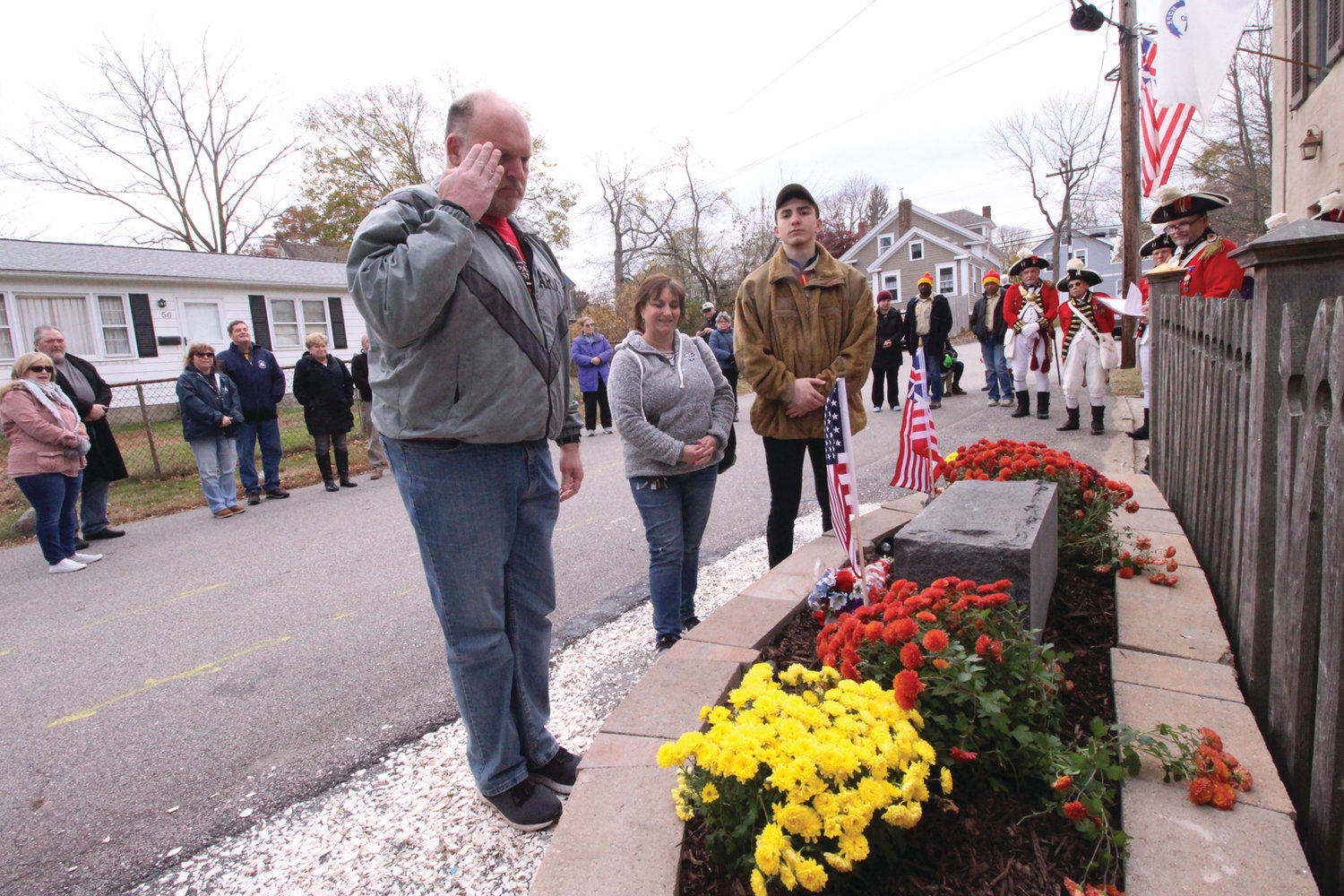 AT DEDICATION: James Loffler, his wife and his son Nicholas stand at the memorial garden at the Pawtuxet Rangers Armory. Nicholas built the garden as his Eagle Scout project.